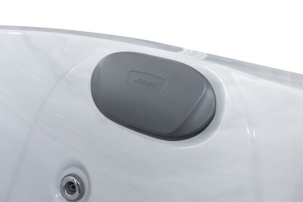 Close-up of a grey oval trunk latch on the white car's rear hatch.