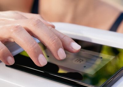 Person tapping a contactless card on a payment terminal at checkout
