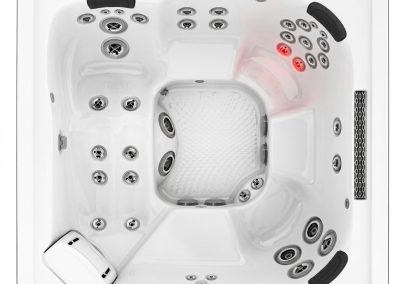 Top-down view of a white square spa hot tub with multiple built-in seats and numerous jets, black headrests, a control panel in one corner, and red status lights.