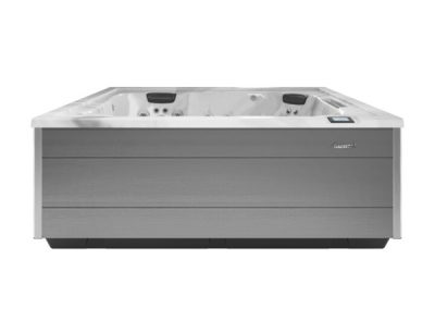 Grey rectangular outdoor hot tub with a white interior, built-in seating and multiple jets; control panel on the right side.