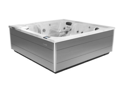 Rectangular gray hot tub with a white interior, built-in jets and headrests, and a digital control panel on the side.
