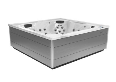 Rectangular gray outdoor hot tub with a white interior and multiple jet nozzles.