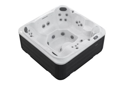White rectangular hot tub with built-in seats and numerous jets, encased in a black exterior and with a side control panel.