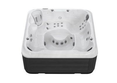 White acrylic hot tub with built-in seating and multiple massage jets, viewed from above.