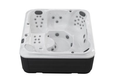 White rectangular hot tub with multiple built-in jets and seating, black exterior paneling visible at the bottom edge.