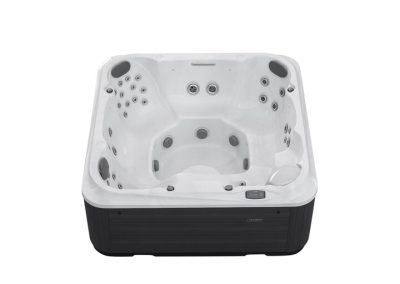 White acrylic outdoor hot tub with multiple jet nozzles and built-in seating, black base panels visible outside the tub