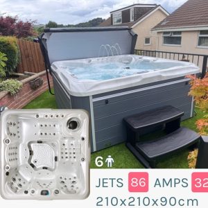 Outdoor above-ground hot tub with lid open, black steps, and a garden fence in a backyard; inset shows the jet-rich interior.