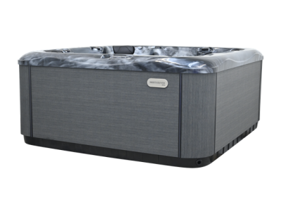 Rectangular outdoor hot tub with gray paneling and a closed cover, brand NorthRiver visible on the side
