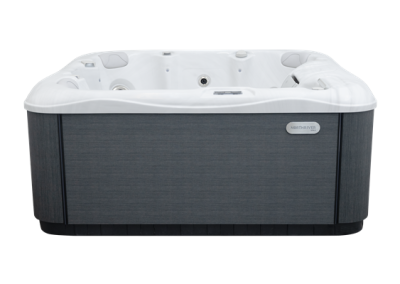 White hot tub with seating and multiple jets, dark gray cabinet panels outdoorsor in a showroom setting, brand badge visible.