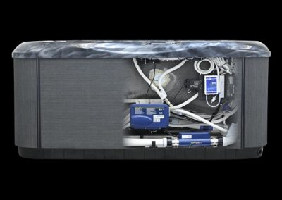 Side panel removed view of a hot tub showing its internal components: blue control box, pumps, white plumbing pipes, and wiring inside the cabinet